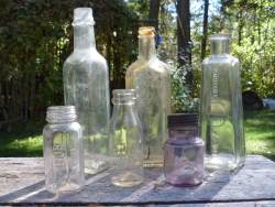 Antique Glass Bottles, some showing the amethyst color of extreme age