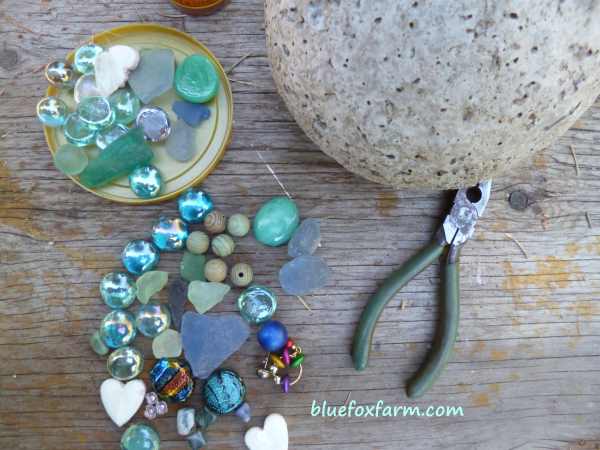 A collection of sea glass, marbles, beads and gems