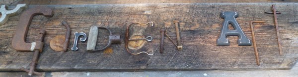 Rustic sign saying Garden Art spelled out in implements