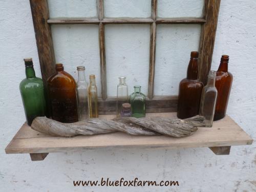 Natural twisted driftwood accents the bottle collection