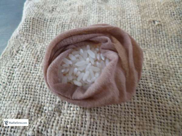 Toe of panty hose filled with rice