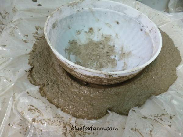 Using a plastic bowl to mold the inside of the birdbath