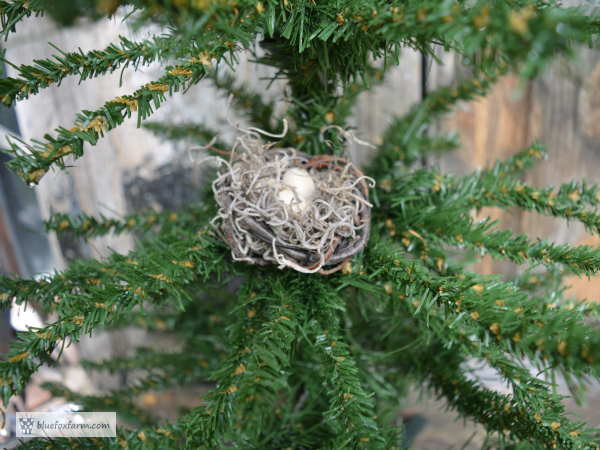 Trimmed, and trimmed with a faux birds nest