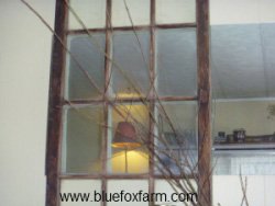 Old window placed over a mirror gives a rustic ambiance
