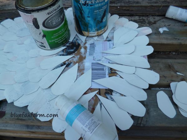 Glue the 'feathers' in rows, and weight them with paint cans