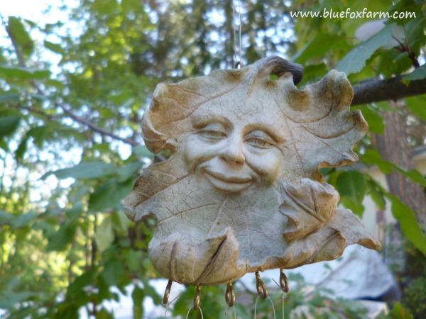 The Green Man is a common motif in garden art, this one is a wind chime...