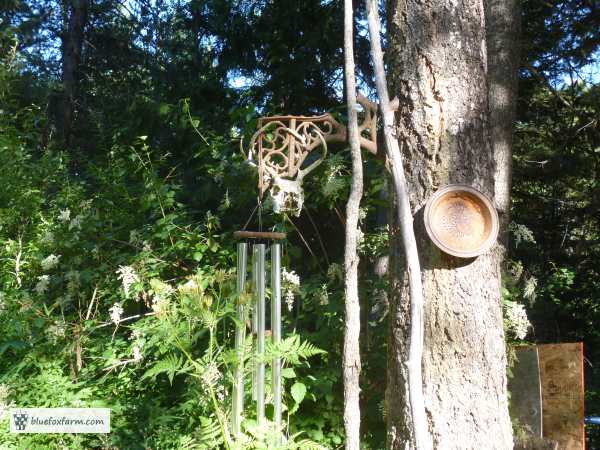Cast metal school bench support makes a handy hanger for the wind chimes