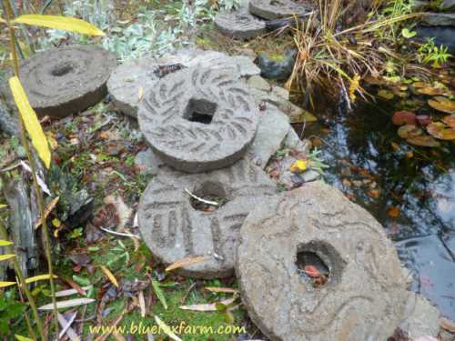 Displayed by the pond, the Hypertufa Millstones